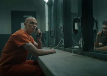 Nicholas Hoult's Lex Luthor and Frank Grillo's Rick Flag speaking through a prison meeting room phone