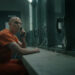 Nicholas Hoult's Lex Luthor and Frank Grillo's Rick Flag speaking through a prison meeting room phone