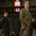 From left to right: Josh O'Connor leaning against a church bench and Daniel Craig holding a coat and hat as Benoit Blanc in Wake Up Dead Man.