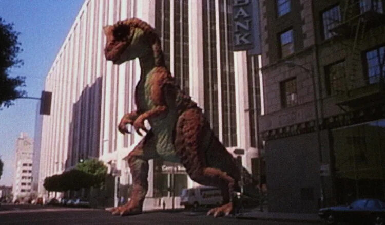 A dinosaur walking down the street in a fake TV commercial in RoboCop