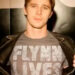 Sam opens jacket to reveal "Flynn Lives" shirt in "Tron: The Next Day" (2011)
