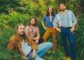 The Sheepdogs posing in foliage.