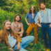 The Sheepdogs posing in foliage.