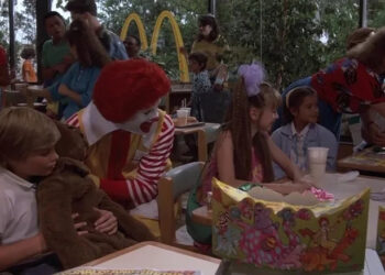 Ronald McDoland and Eric wheeling up to a table in Mac and Me