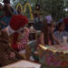 Ronald McDoland and Eric wheeling up to a table in Mac and Me