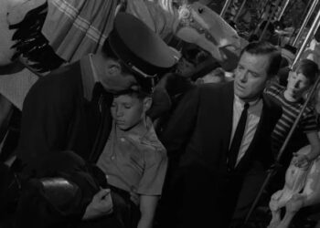 Martin Sloan standing next to a cop holding Martin's younger self in The Twilight Zone