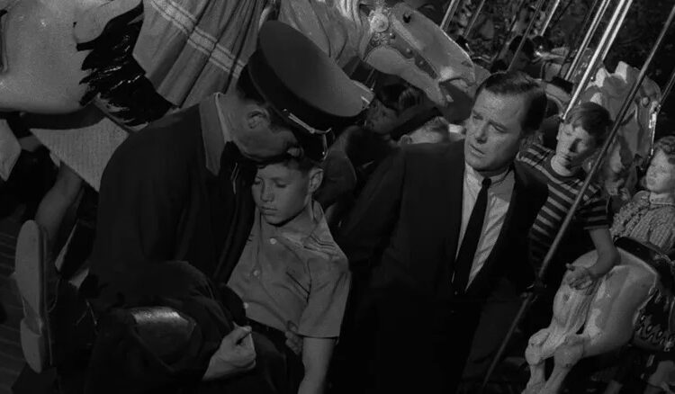 Martin Sloan standing next to a cop holding Martin's younger self in The Twilight Zone