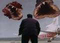 A man in a black suit seen from behind staring at two circle teeth monsters on The Langoliers