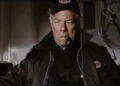 George Kennedy's Joe Petroni looking serious and smoking a cigar in Airport