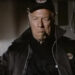 George Kennedy's Joe Petroni looking serious and smoking a cigar in Airport