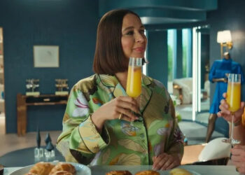 Molly holding a mimosa and talking to Nicholas on Loot
