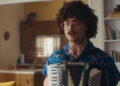 Al playing an accordion in Weird
