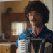 Al playing an accordion in Weird