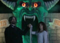 Dr. Mortis and wife in front of Dr. Mortis' House of Horrors home haunt in V/H/S/Halloween.