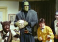 Bruce, Frank, Walt, and Dracula looking ready to fight in an office in Monster Squad