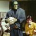 Bruce, Frank, Walt, and Dracula looking ready to fight in an office in Monster Squad