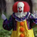 Pennywise cackling and holding balloons in It