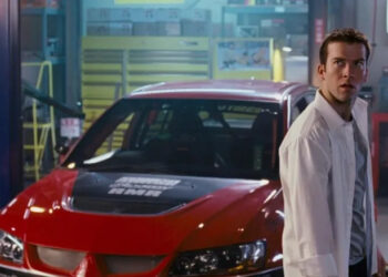 Sean in front of a red car in The Fast and the Furious: Tokyo Drift