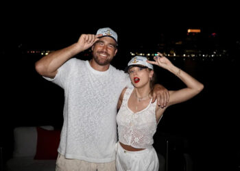 Travis Kelce poses with Taylor Swift