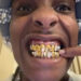 A$AP Rocky showing off gold grills with a close-up smile. Tyler, the Creator is in a small video call window.