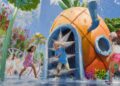a rendering of kids playing in and around a splash-zone pineapple