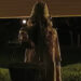 Creepy ghost woman holding basket in doorway in V/H/S/Halloween.