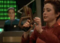 Kira holding a phaser with Dax in the background on Star Trek: Deep Space Nine