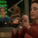 Kira holding a phaser with Dax in the background on Star Trek: Deep Space Nine