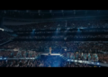 A huge stadium filled with fans watching Beyoncé perform, centre stage. 