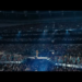 A huge stadium filled with fans watching Beyoncé perform, centre stage. 