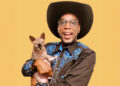 a man in a cowboy hat holding a cat