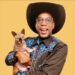 a man in a cowboy hat holding a cat
