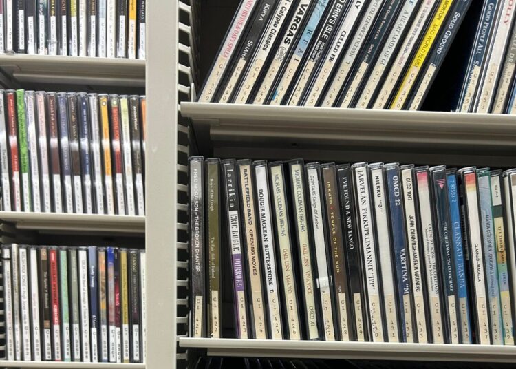 A shelf with many dvd cases.