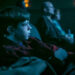 Miles Ekhardt's Matty sitting in a movie theater in It: Welcome to Derry