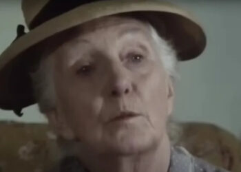 Joan Hickson's Miss Marple wearing a beige hat and looking thoughtful on Miss Marple