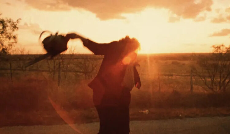 Gunnar Hansen's Leatherface dances in the sunset in The Texas Chainsaw Massacre