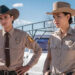 Kiowa Gordon as Jim Chee and Jessica Matten as Bernadette Manuelito wearing cowboy hats in Dark Winds