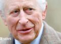 King Charles wears a sandy-coloured overcoat and white shirt while attending a service at the Church of St Mary the Virgin, close to the Sandringham Estate in Norfolk, England, on 26 January, 2025.