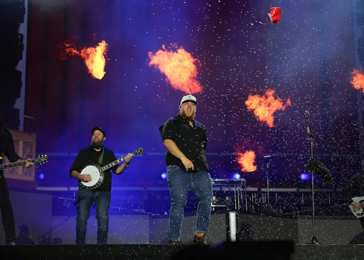 Luke Combs drop kicks a red solo cup during his performance on the Mane Stage during the Stagecoach Festival in Indio, Calif., April 27, 2025.