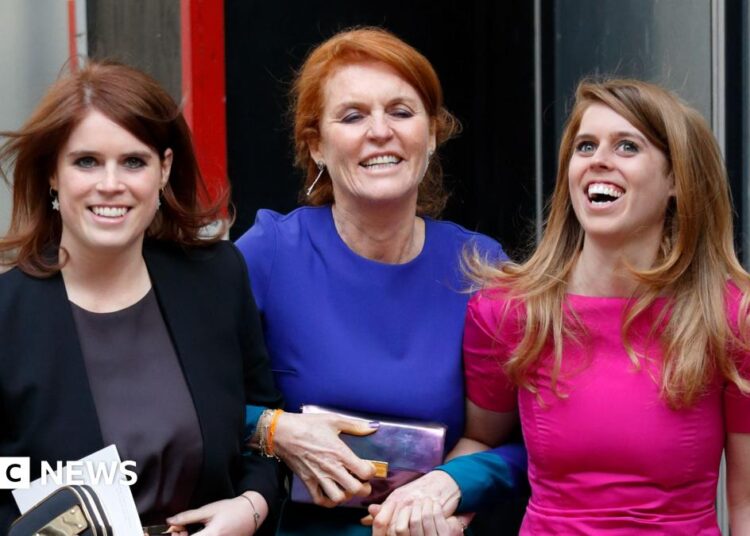 Princess Beatrice, Sarah Ferguson and Princess Eugenie in dresses smile as they link arms walking