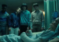 A still, showing Max in a coma surrounded by the others, from Season 4 of 'Stranger Things.'