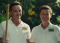 I'm A Celebrity hosts Ant and Dec wearing white shirts, with Ant holding a stick
