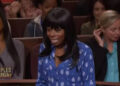 A person wearing a blue patterned shirt appears surprised or distressed in a courtroom setting on a TV show