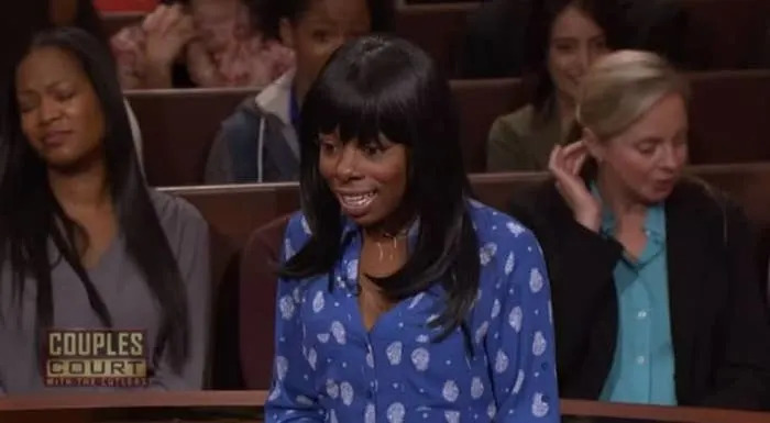 A person wearing a blue patterned shirt appears surprised or distressed in a courtroom setting on a TV show