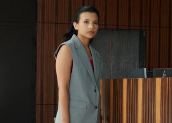 Jackie standing in a lobby in "My Life with the Walter Boys" (2023-present)