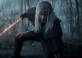 Geralt kneeling down and holding a sword on The Witcher