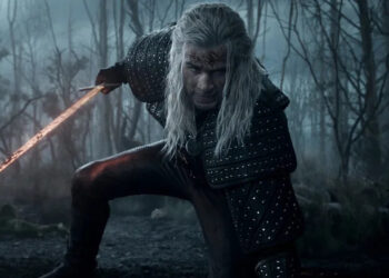 Geralt kneeling down and holding a sword on The Witcher