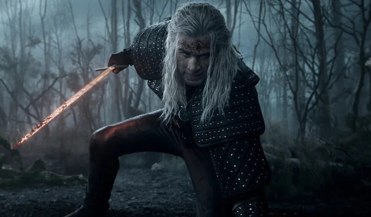 Geralt kneeling down and holding a sword on The Witcher