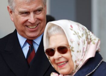 The Queen, in a silk scarf and sunglasses, laughs with Prince Andrew