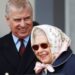 The Queen, in a silk scarf and sunglasses, laughs with Prince Andrew